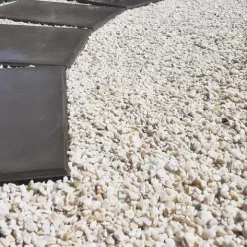 Piedra blanca partida 0.3 JardinX 25 kg, piedra natural decorativa lavada ideal para jardines, macetas y canteros.